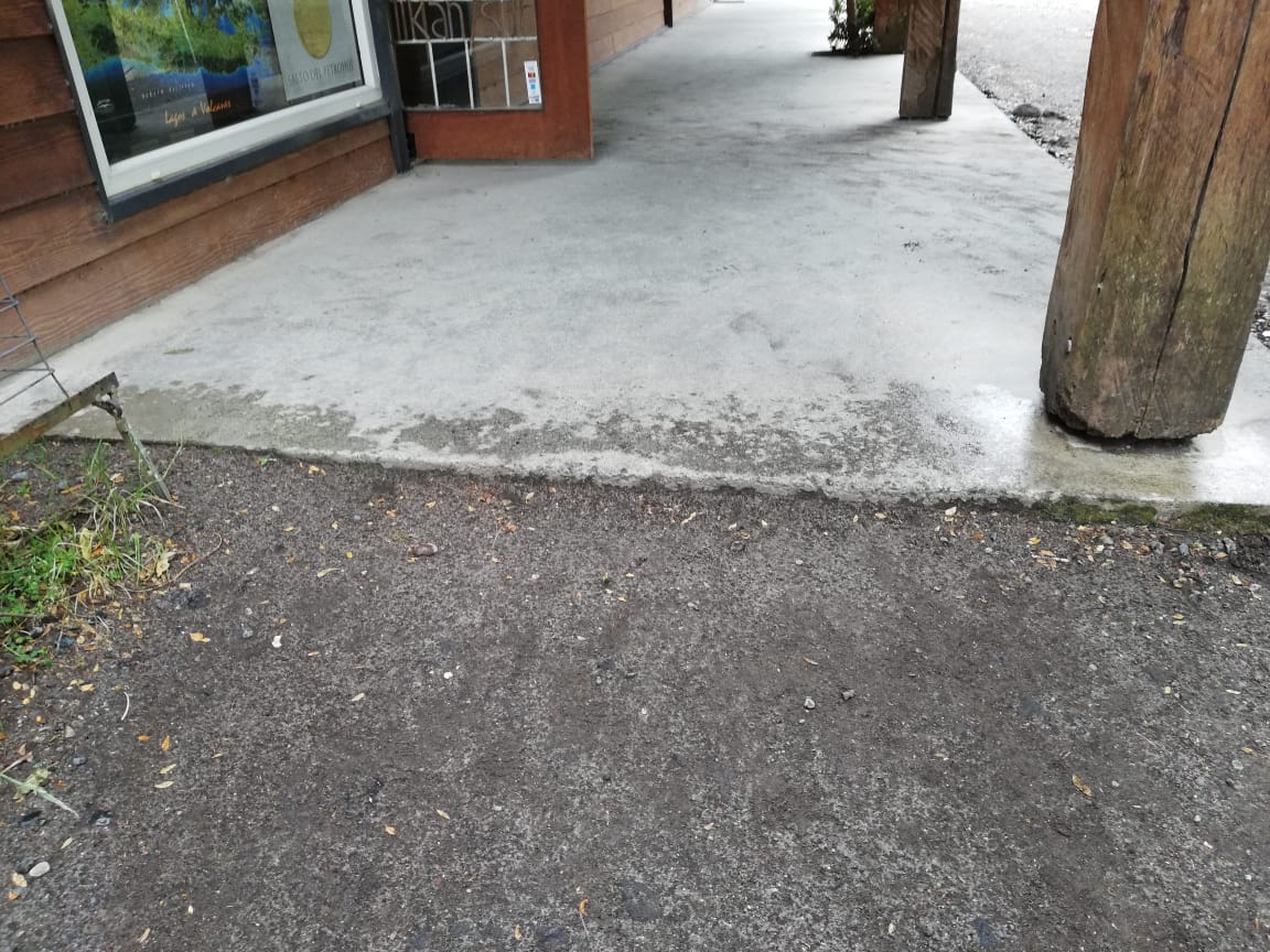 acceso con pequeño desnivel provocado por el cambio de cemento a tierra en la entrada del recinto